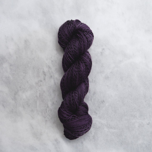 Dark purple skein of yarn with black stripes.