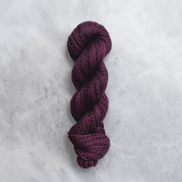 Dark violet skein of yarn with black stripes.