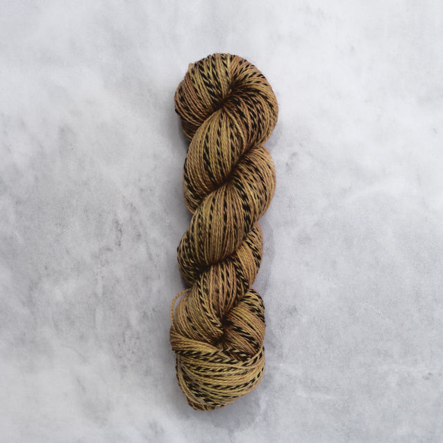 Yellowish brown skein of yarn with black stripes.