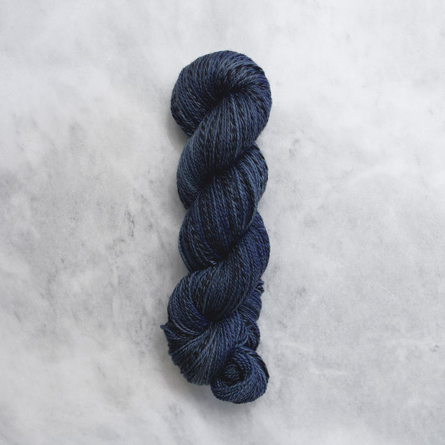 Navy blue skein of yarn with black stripes.