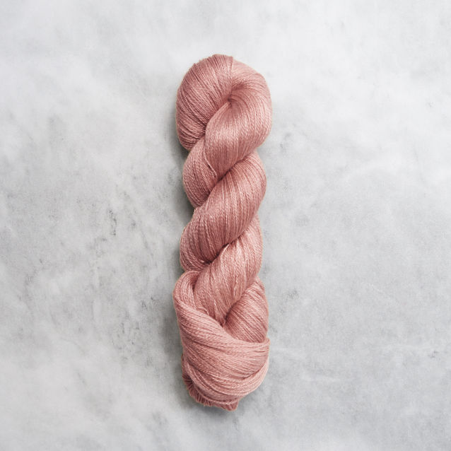 Coral pink skein of yarn with silver shimmer.