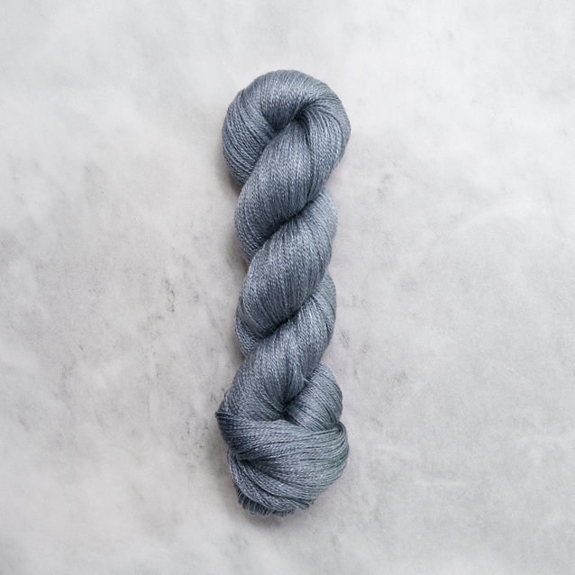 Jeans blue skein of yarn with silver shimmer.