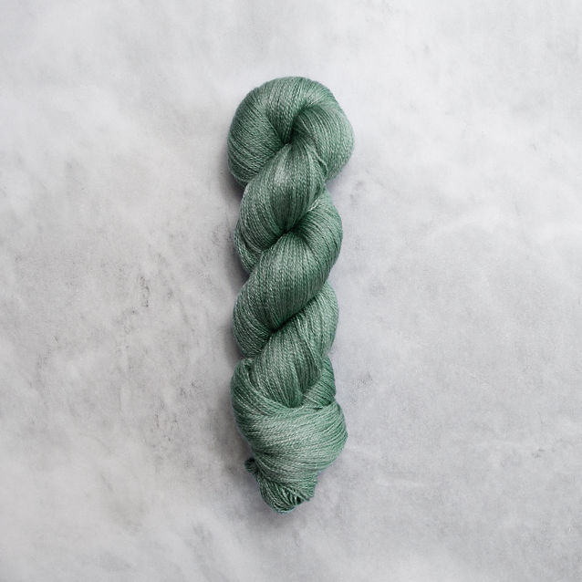 Medium green skein of yarn with silver shimmer.