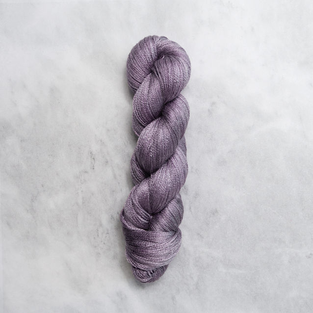 Medium purple skein of yarn with silver shimmer.