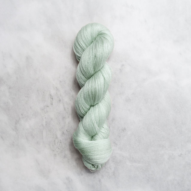 Mint green skein of yarn with silver shimmer.