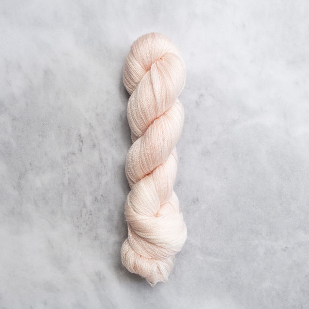 Peachy pink skein of yarn with silver shimmer.