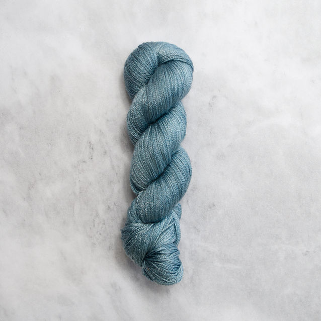 Ocean blue skein of yarn with silver shimmer.