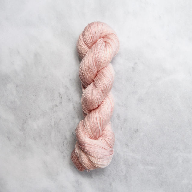 Dark peachy pink skein of yarn with silver shimmer.