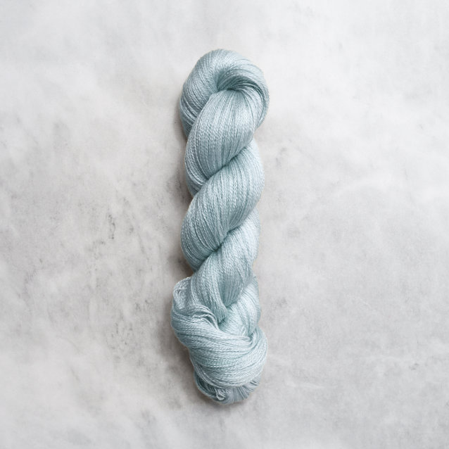 Light ocean blue skein of yarn with silver shimmer.